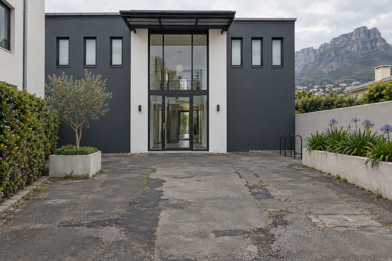 Generated before view of patched tarmac outside a fictional Cape Town apartment building