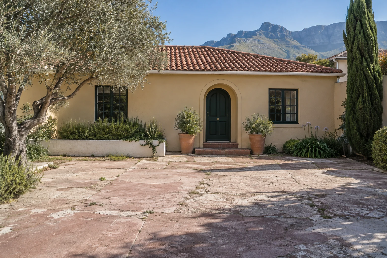 Generated before view of a cracked concrete court outside a fictional Cape Town guesthouse