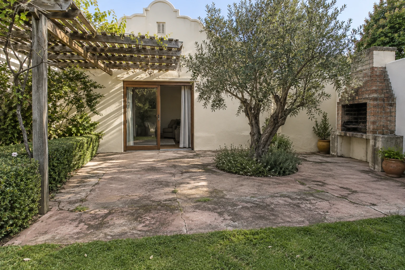 Generated before view of a cracked rear terrace with an olive tree and built-in braai