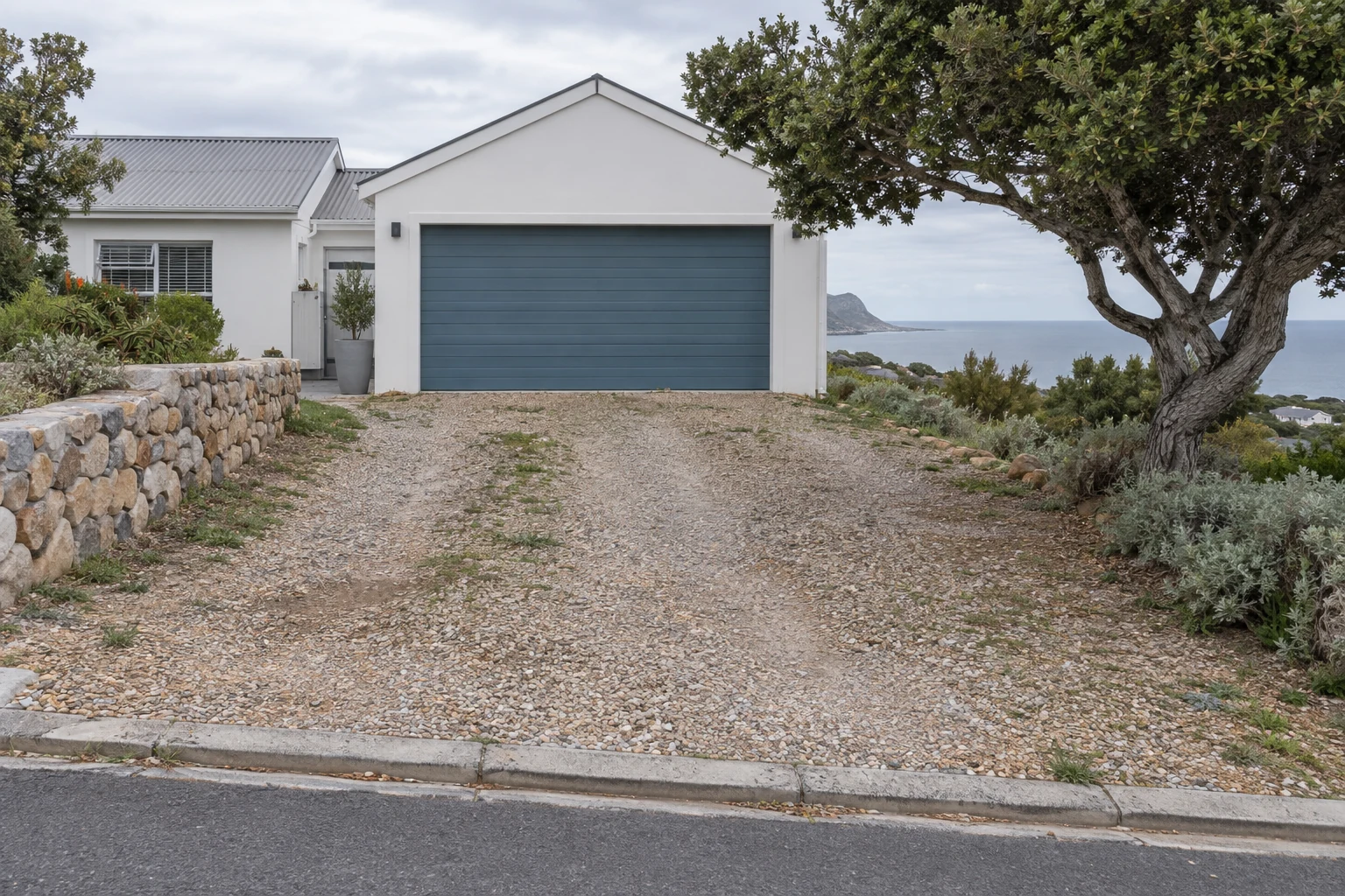 Generated view of a gravel driveway at a fictional coastal home