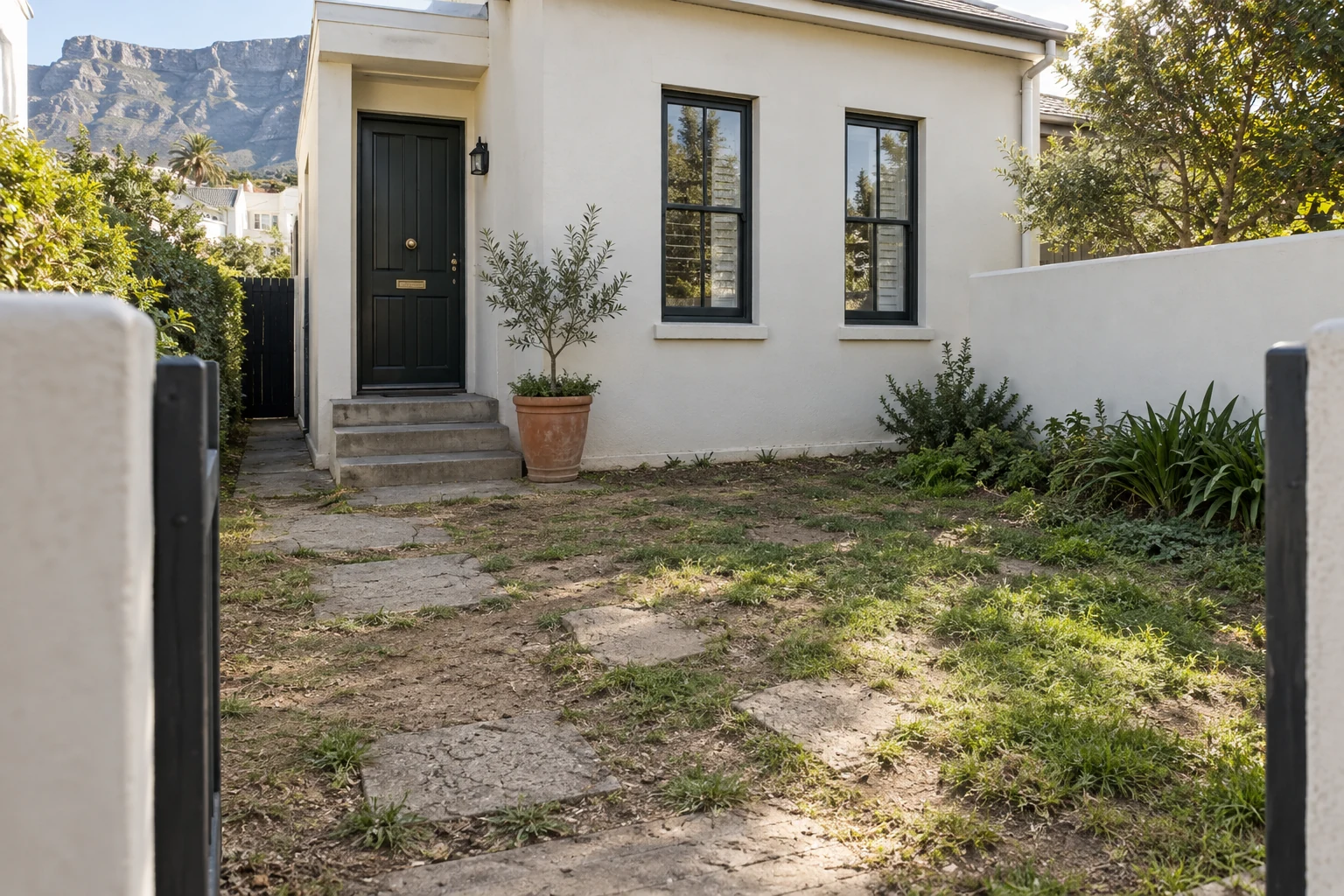 Generated before view of a worn entrance court at a fictional Cape Town townhouse