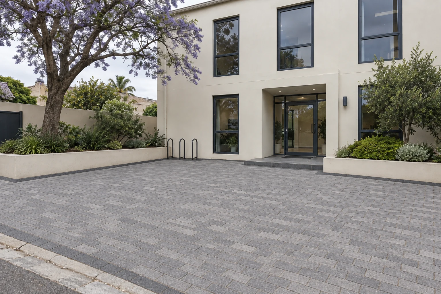 Generated view of the same fictional office forecourt with grey interlocking paving
